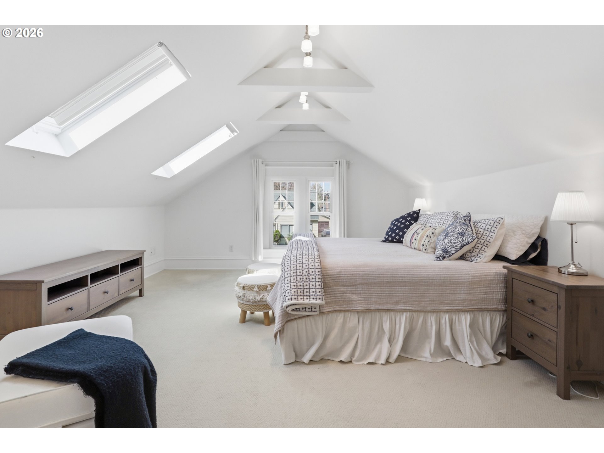 3326 Northeast 60th Avenue Portland, OR 97213 - Photo 30 of 46 a bedroom with a large bed and a chandelier