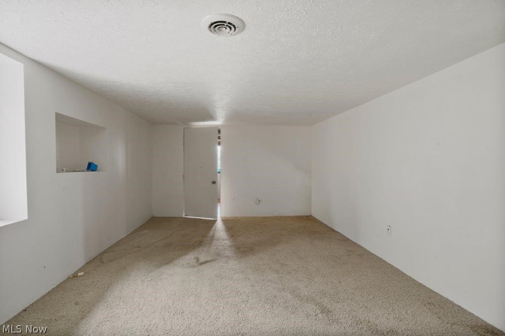 4325 Mayfair Road Uniontown, OH 44685 - Photo 25 of 35 Carpeted spare room with a textured ceiling