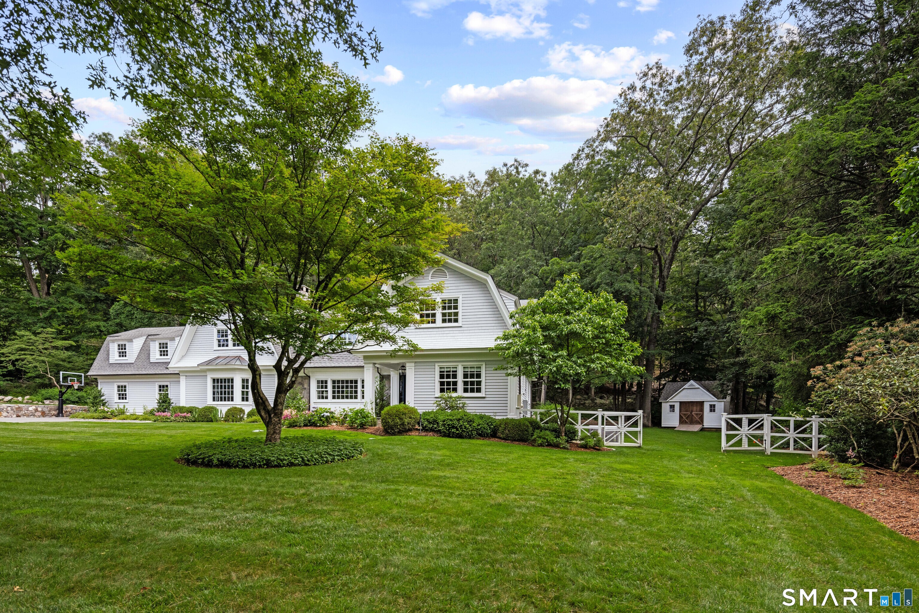 99 Hickok Road New Canaan, CT 06840 - Photo 34 of 39 a front view of a house with a garden