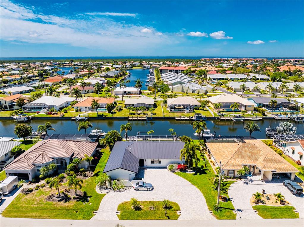 391 Vía Esplanade Punta Gorda, FL 33950 - Photo 1 of 60 an aerial view of a house with a swimming pool