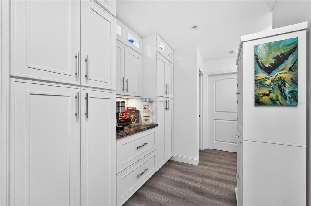 391 Vía Esplanade Punta Gorda, FL 33950 - Photo 12 of 60 a kitchen with white cabinets and white appliances