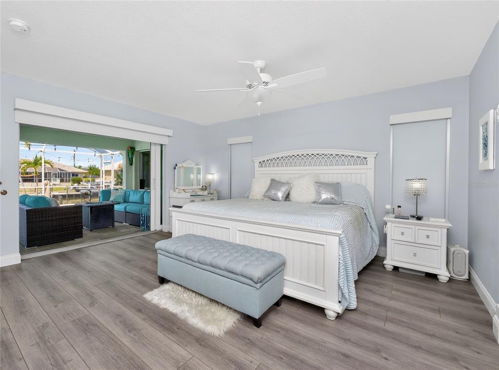 391 Vía Esplanade Punta Gorda, FL 33950 - Photo 23 of 60 a spacious bedroom with a bed and a large window