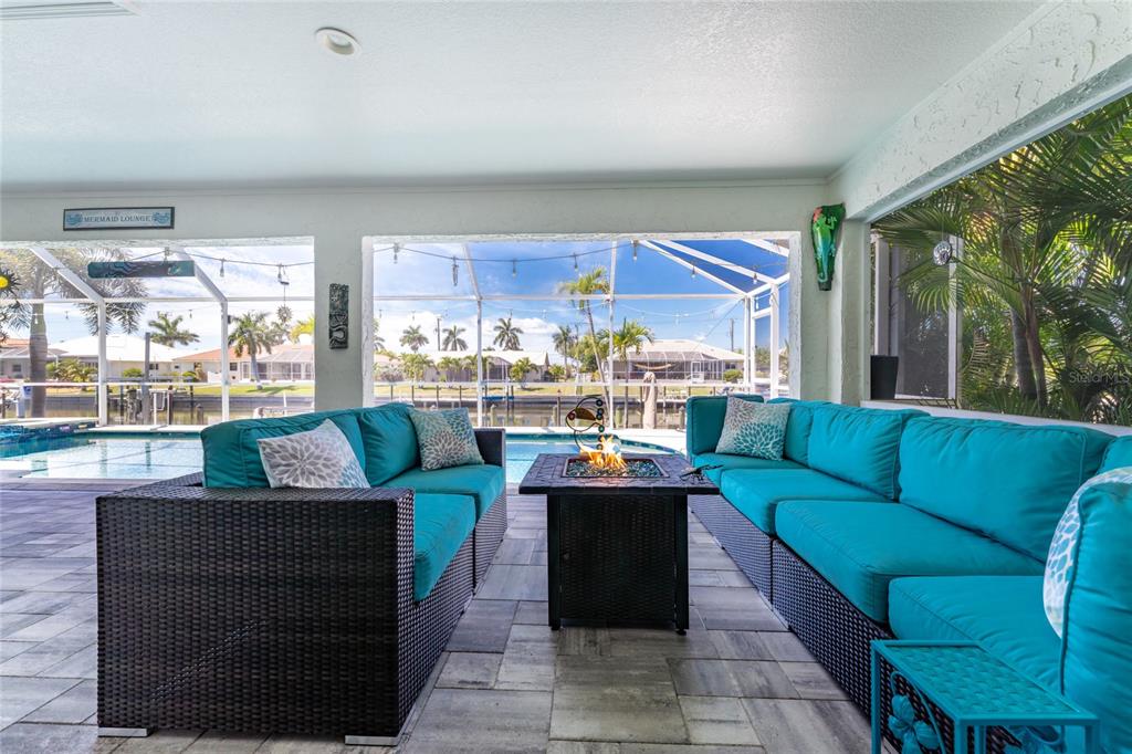 391 Vía Esplanade Punta Gorda, FL 33950 - Photo 25 of 60 a living room with furniture and a floor to ceiling window
