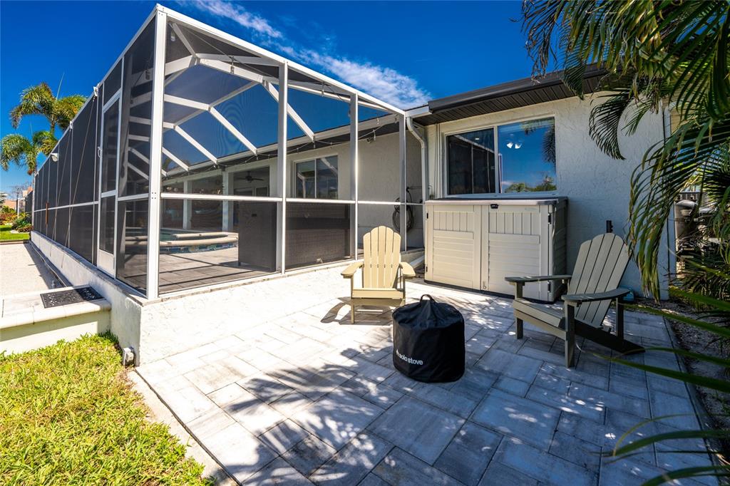 391 Vía Esplanade Punta Gorda, FL 33950 - Photo 32 of 60 a view of a patio with table and chairs potted plants with wooden floor and fence