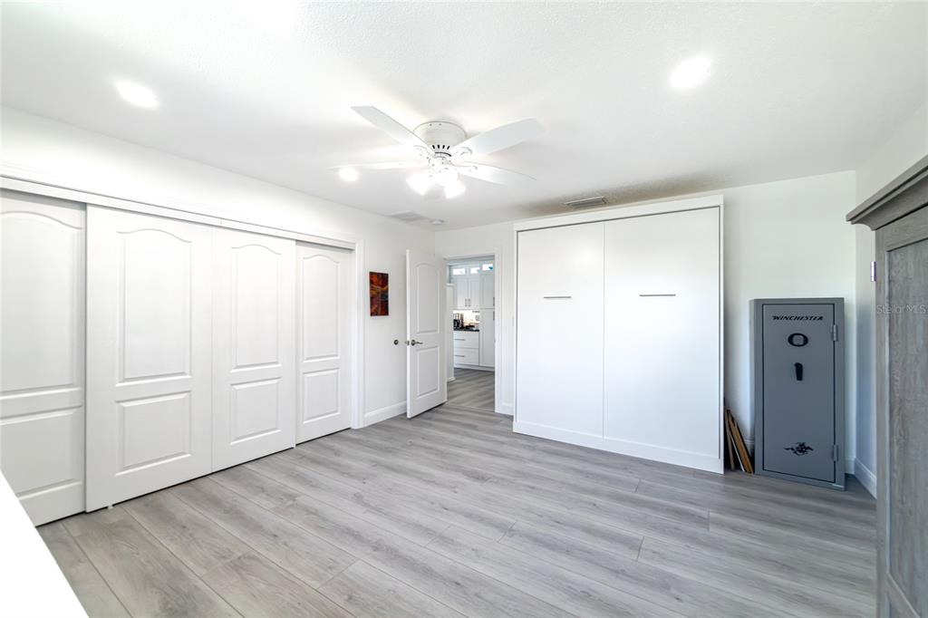391 Vía Esplanade Punta Gorda, FL 33950 - Photo 39 of 60 a view of an empty room with wooden floor
