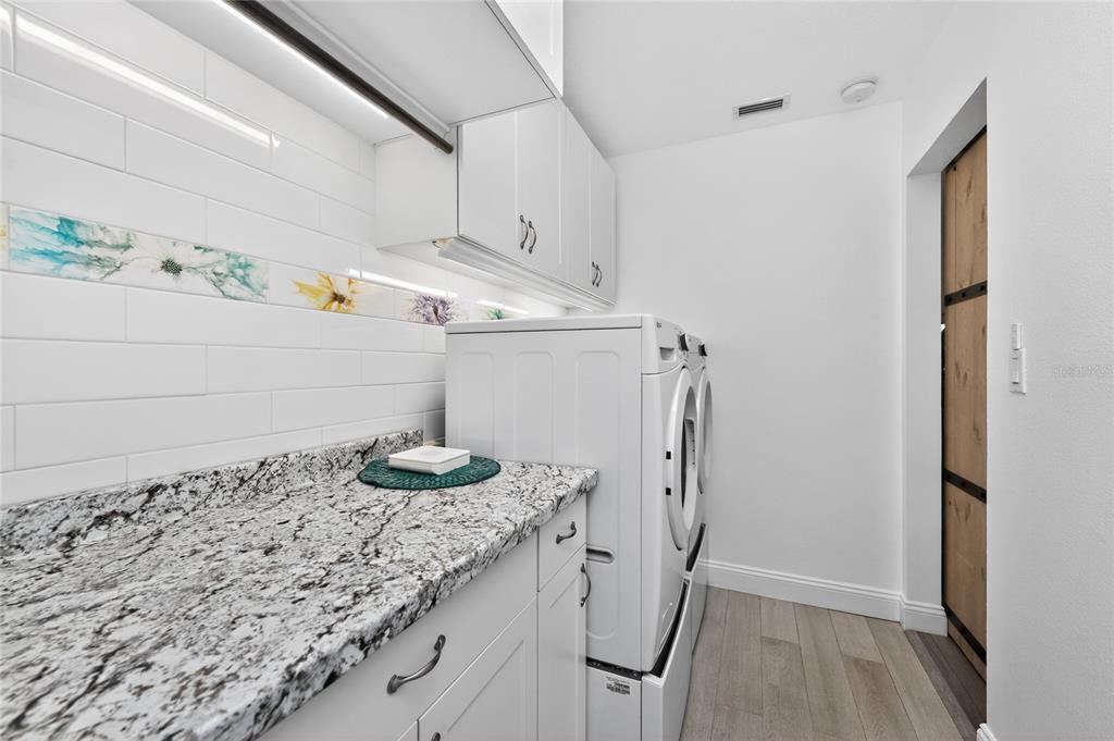 391 Vía Esplanade Punta Gorda, FL 33950 - Photo 47 of 60 a bathroom with a granite countertop sink a vanity and a shower