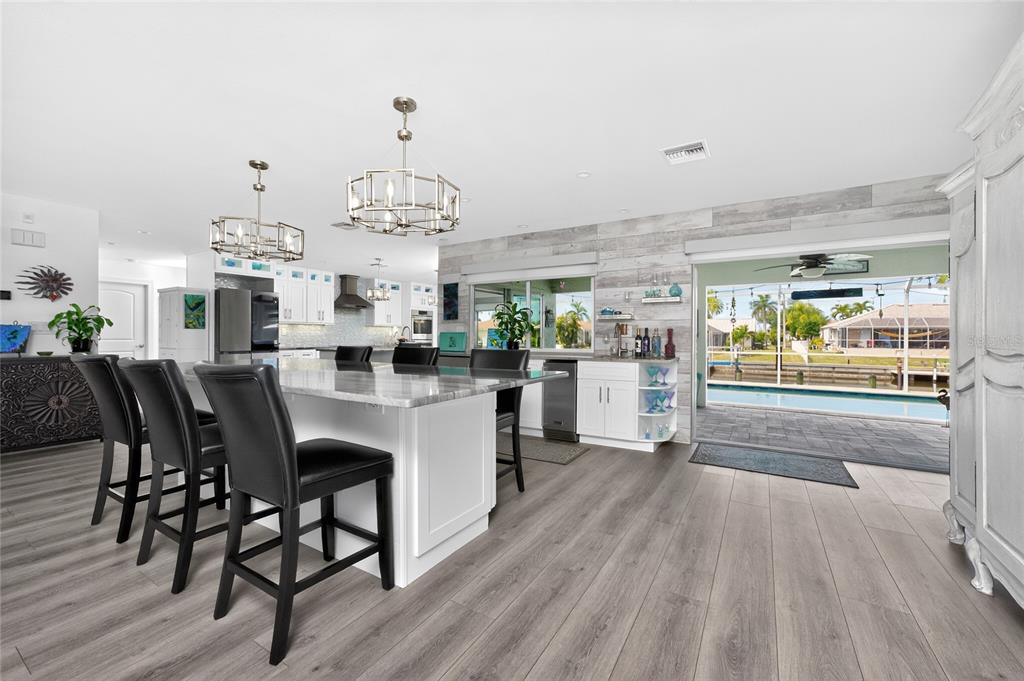 391 Vía Esplanade Punta Gorda, FL 33950 - Photo 5 of 60 a dining room with furniture a chandelier and wooden floor