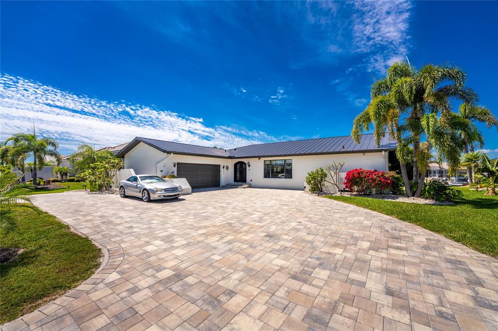 391 Vía Esplanade Punta Gorda, FL 33950 - Photo 60 of 60 a front view of a house with a yard and mountain view
