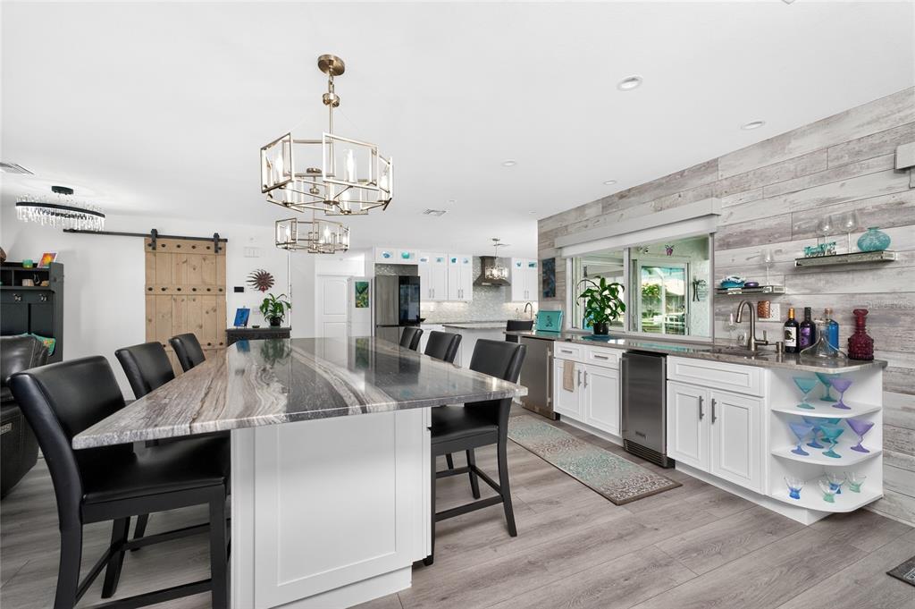 391 Vía Esplanade Punta Gorda, FL 33950 - Photo 6 of 60 a view of a dining room with furniture and wooden floor