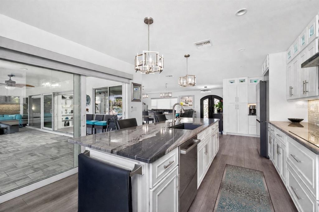 391 Vía Esplanade Punta Gorda, FL 33950 - Photo 10 of 60 a large kitchen with stainless steel appliances granite countertop a lot of counter space and wooden floor
