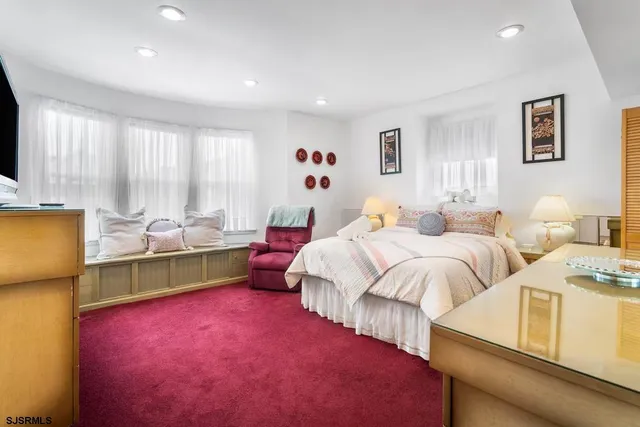 a bedroom with a bed and a television