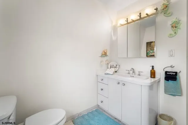 a spacious bedroom with a bed and a lamp