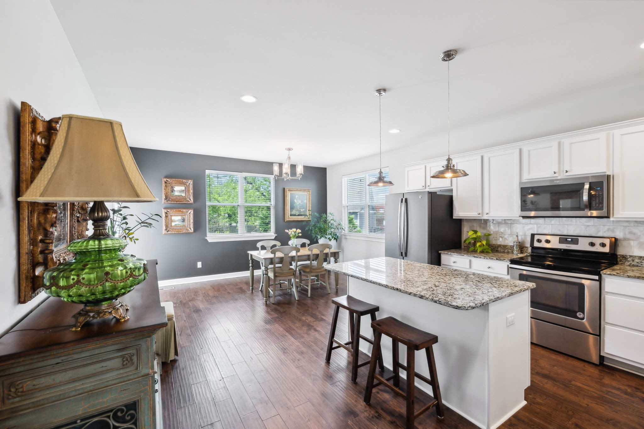 712 Ellie Drive Madison, TN 37115 - Photo 6 of 35 a kitchen with stainless steel appliances granite countertop a stove top oven a sink dishwasher a dining table and chairs with wooden floor