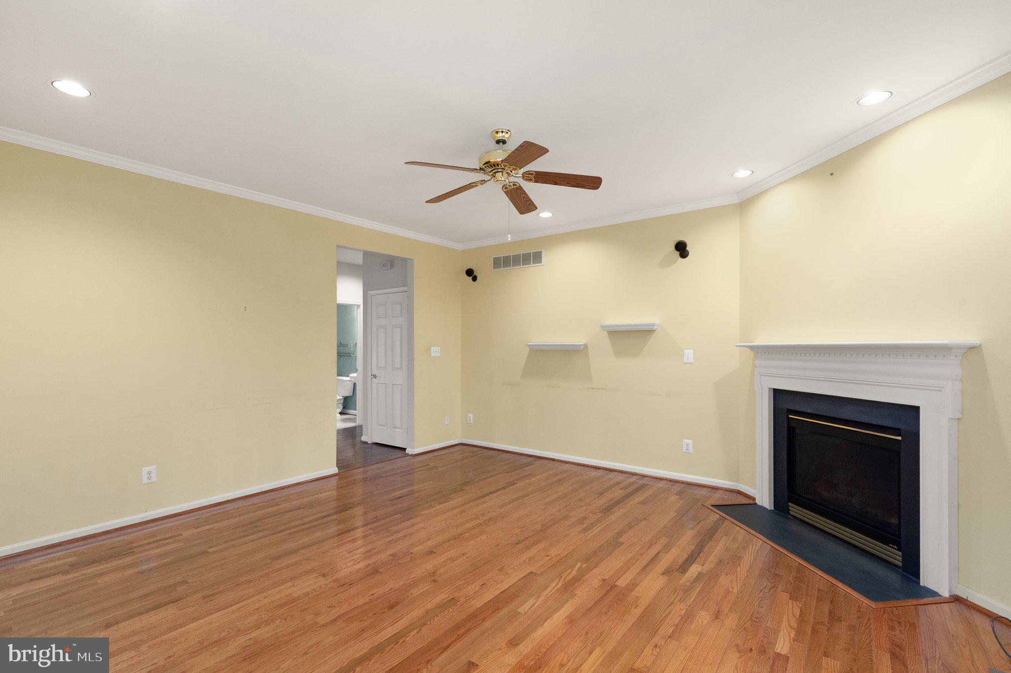 511 Copeland Road Fallston, MD 21047 - Photo 12 of 49 an empty room with chandelier fan and fireplace