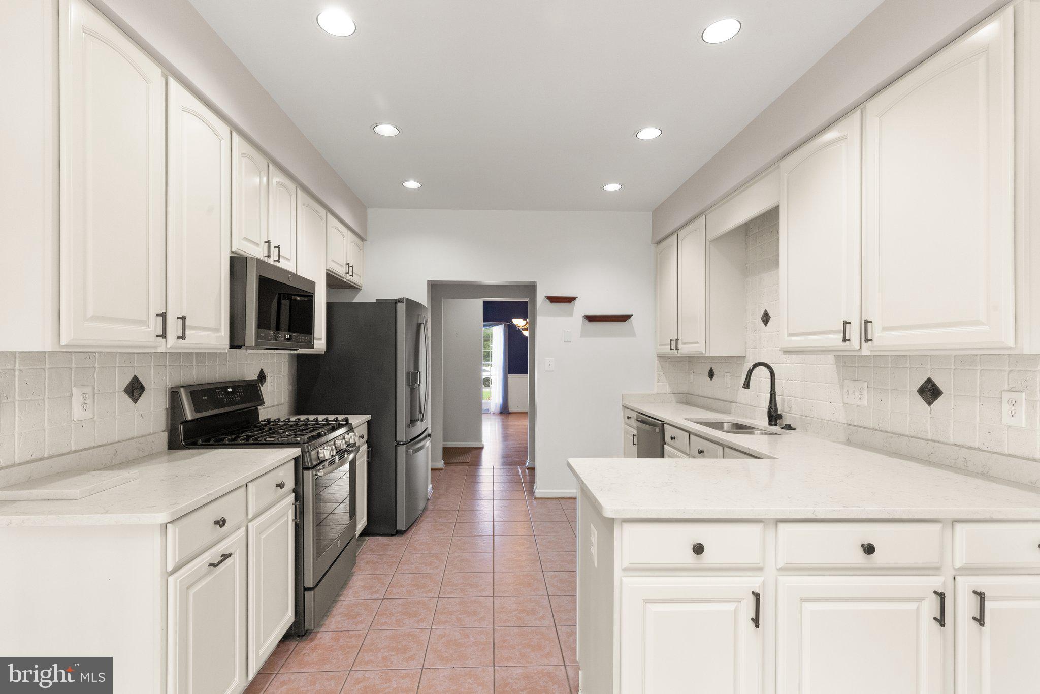 511 Copeland Road Fallston, MD 21047 - Photo 17 of 49 a kitchen with stainless steel appliances a sink a stove a refrigerator cabinets and a window