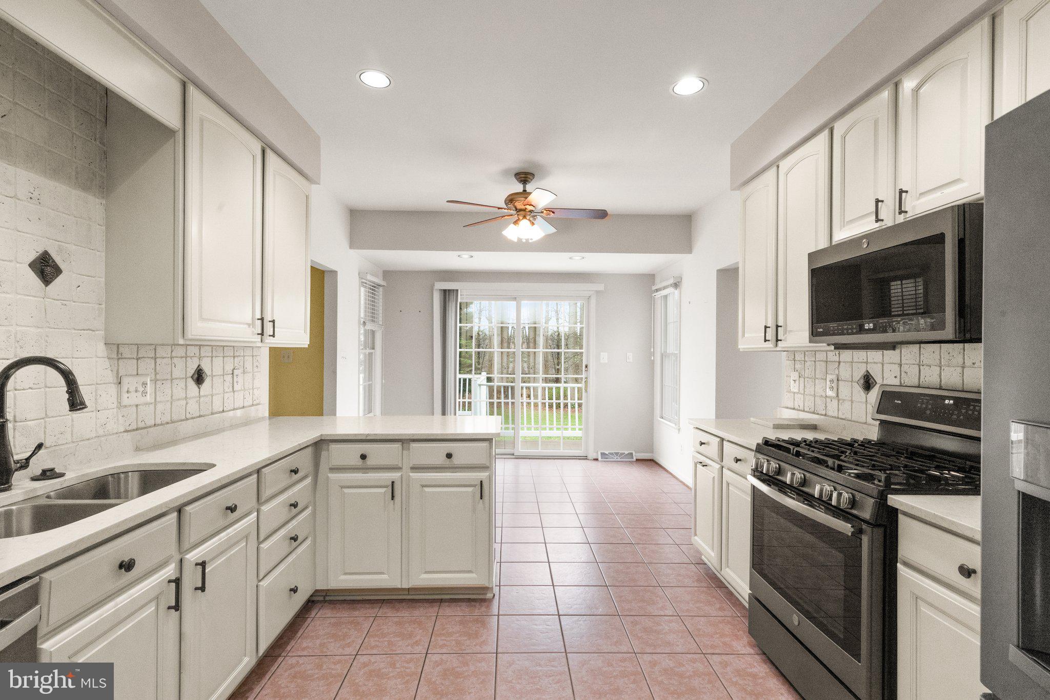 511 Copeland Road Fallston, MD 21047 - Photo 18 of 49 a large kitchen with stainless steel appliances granite countertop a stove top oven a sink a window and a dining table