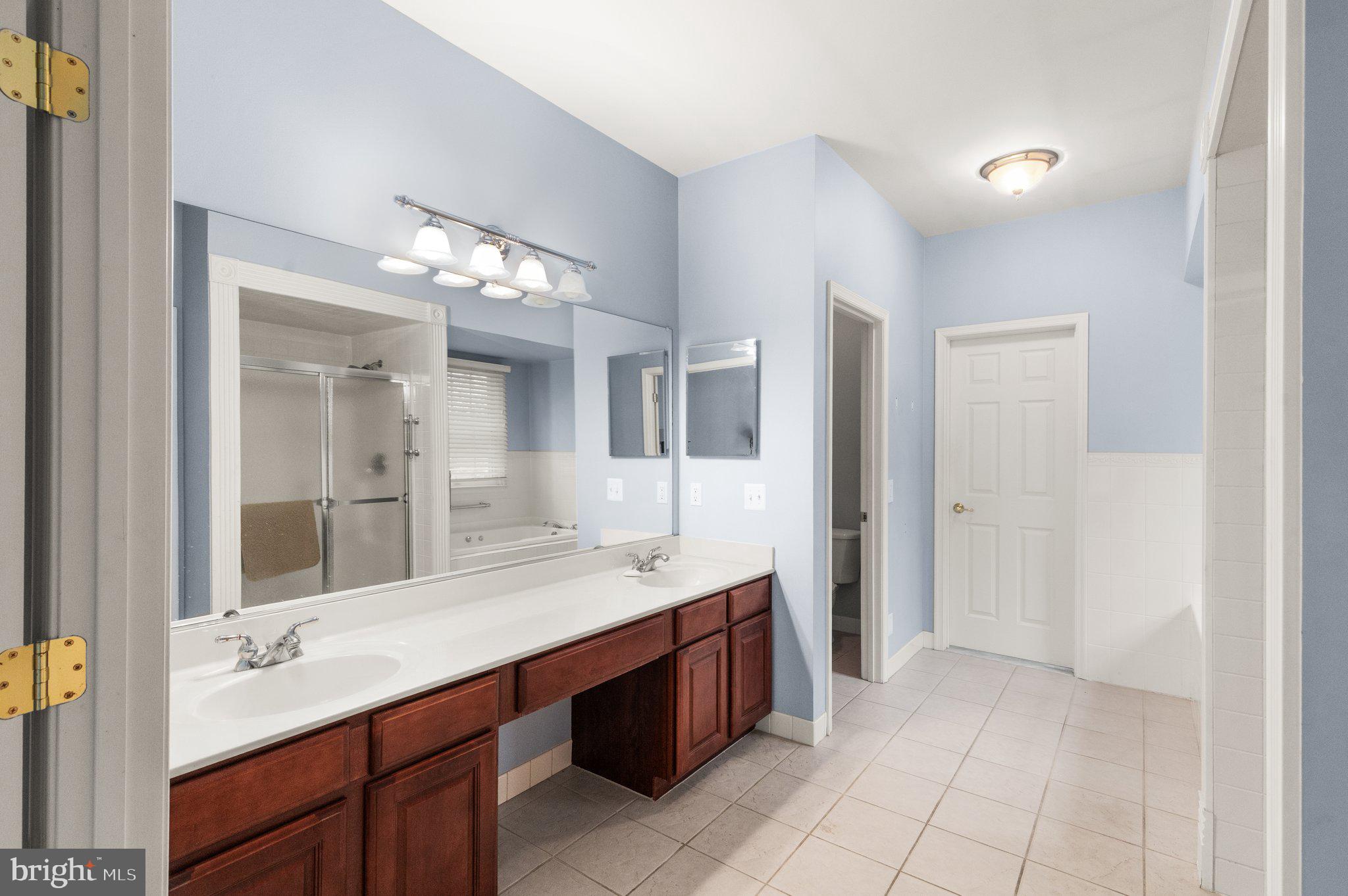 511 Copeland Road Fallston, MD 21047 - Photo 7 of 49 a spacious bathroom with a granite countertop sink and a mirror