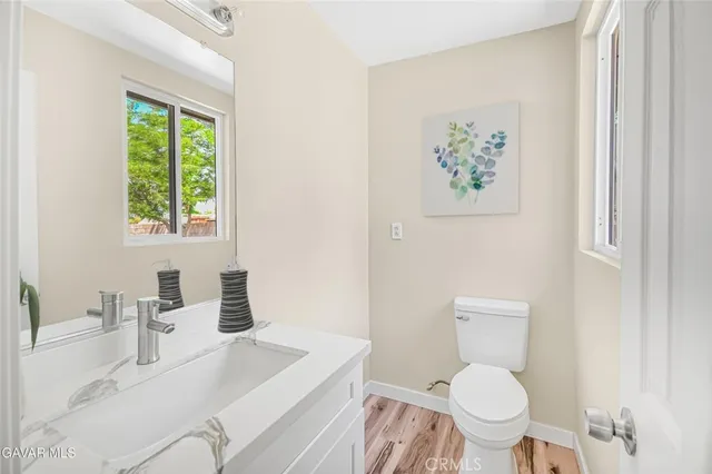 a white toilet sitting next to a bathroom sink