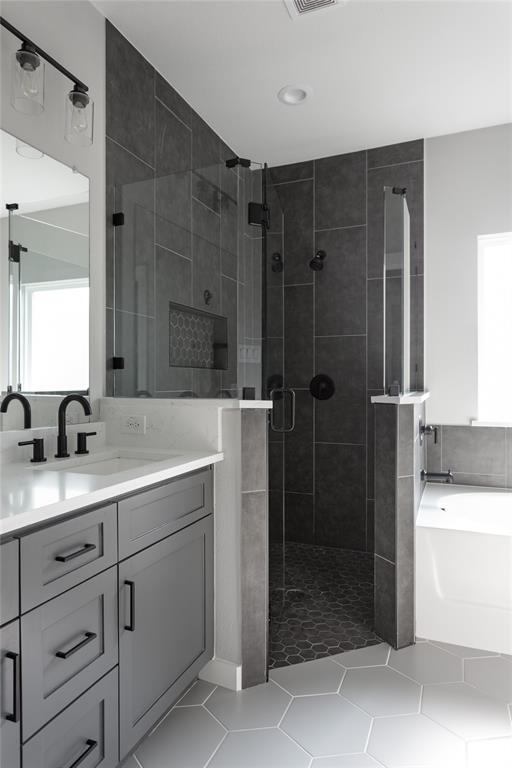 1108 Claude Street Dallas, TX 75203 - Photo 13 of 17 Contemporary bathroom featuring a spacious glass-enclosed shower with dark tile walls and a mosaic-tiled niche
