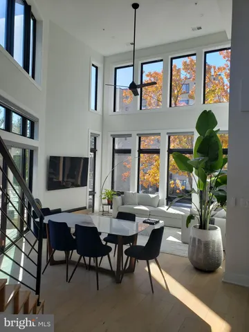 a living room with furniture a chandelier and a window