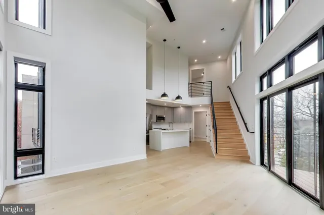 a kitchen with stainless steel appliances a stove microwave and sink