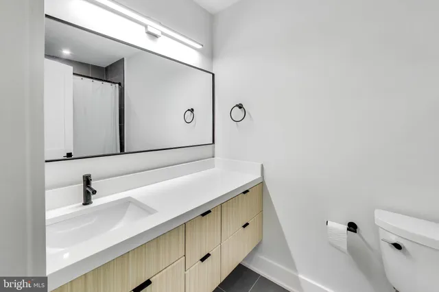 a view of an empty room with glass door and a window