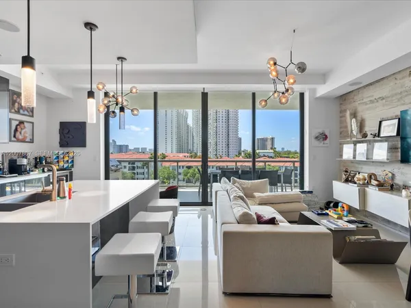 a living room with furniture and a chandelier