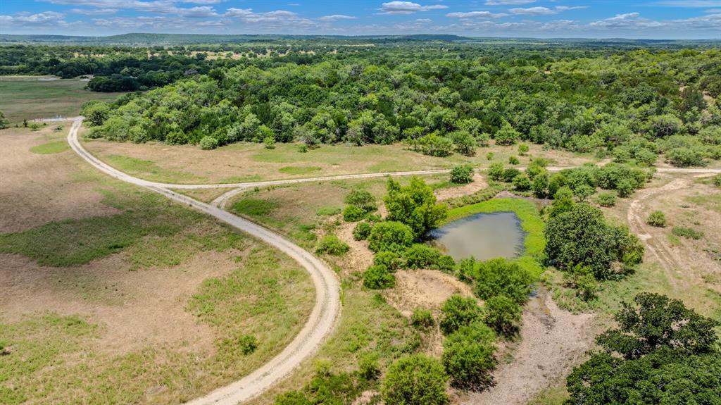 Tbd Cement Mountain Road Bryson, TX 76427 - Photo 11 of 40 a view of a swimming pool with a yard and large trees