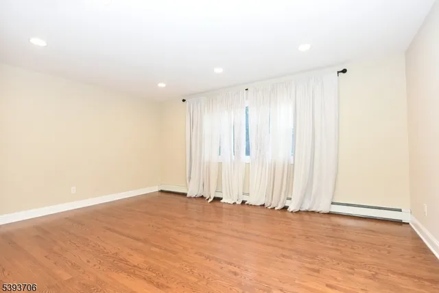 a view of wooden floor and entryway in a room