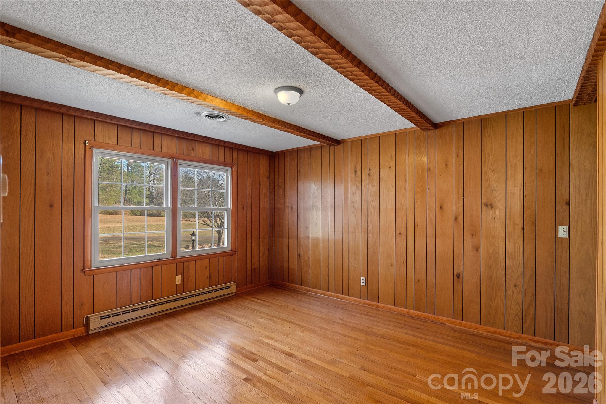 591 Landrum Road Tryon, NC 28782 - Photo 29 of 48 an empty room with wooden floor and windows