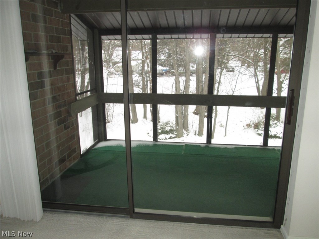 Sliding patio doors to the enclosed screened in porch(8 x 14) with indoor/outdoor carpeting.