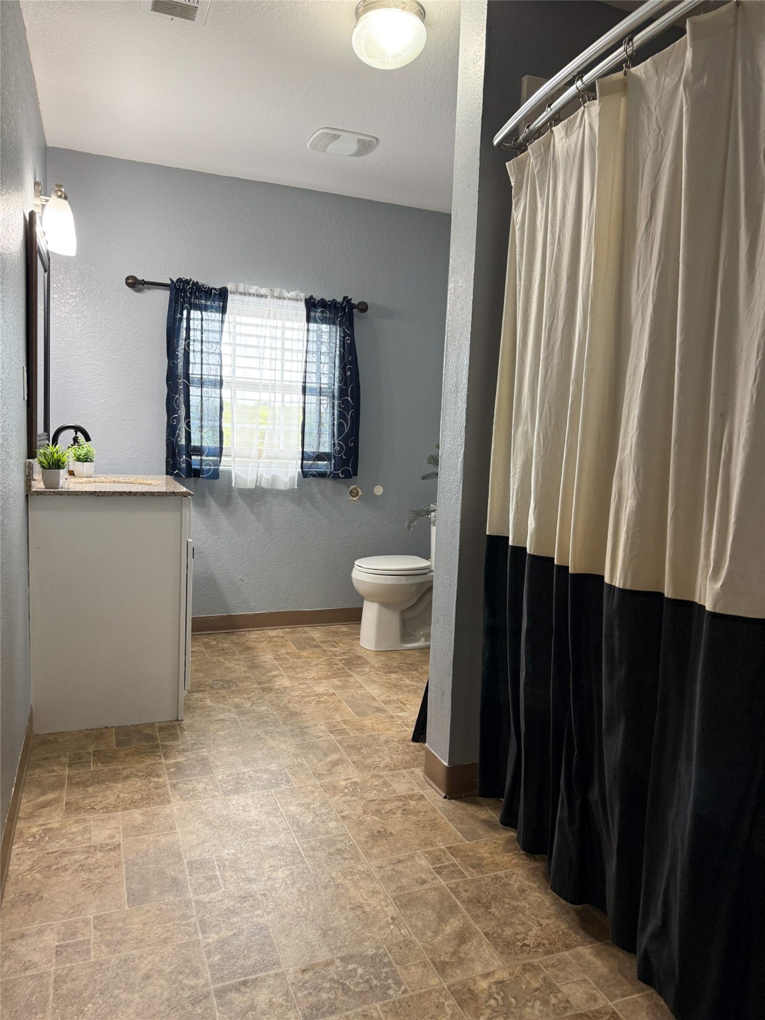 740 Bridget Avenue Buffalo, TX 75831 - Photo 37 of 50 a bathroom with a sink a toilet and shower curtain