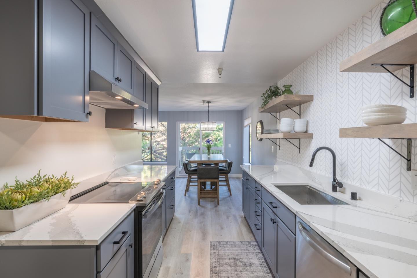 a kitchen with kitchen island a sink stove and cabinets