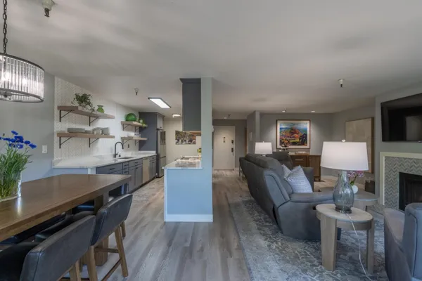 a living room with furniture a dining table and kitchen view