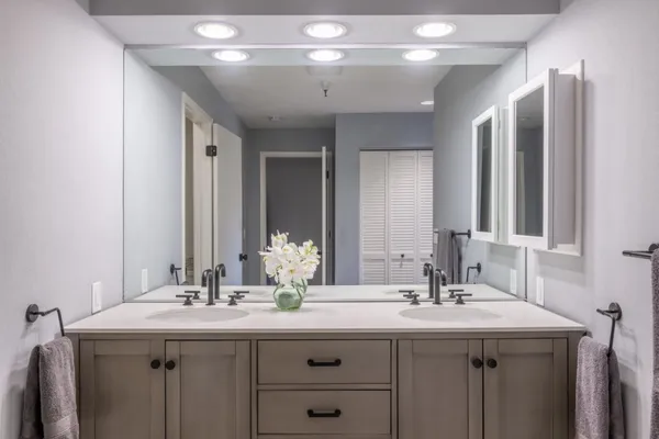 a bathroom with a double vanity sink and a mirror