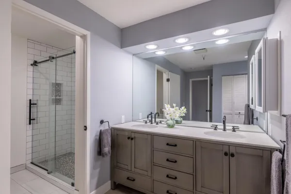 a bathroom with a double vanity sink mirror and double