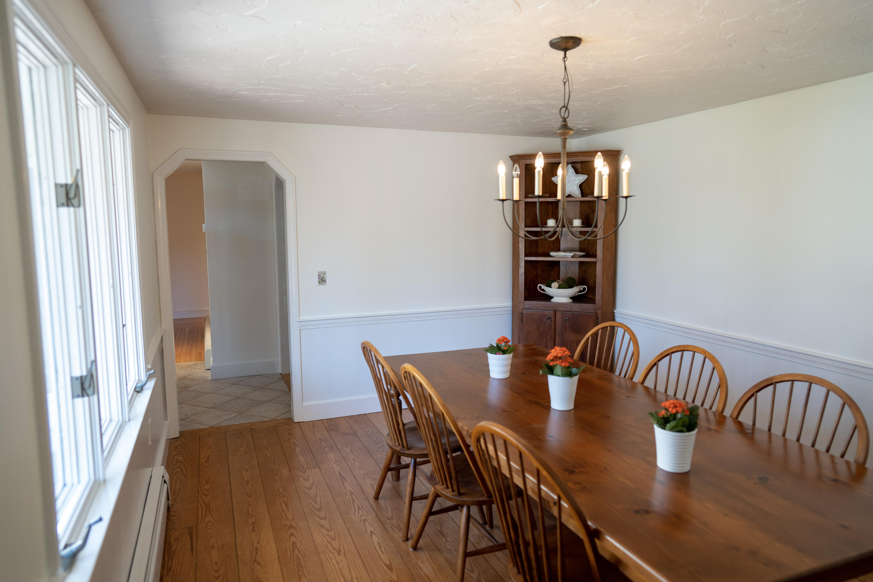 72 Cove Road South Dennis, MA 02660 - Photo 11 of 37 a dining room with furniture a chandelier and wooden floor