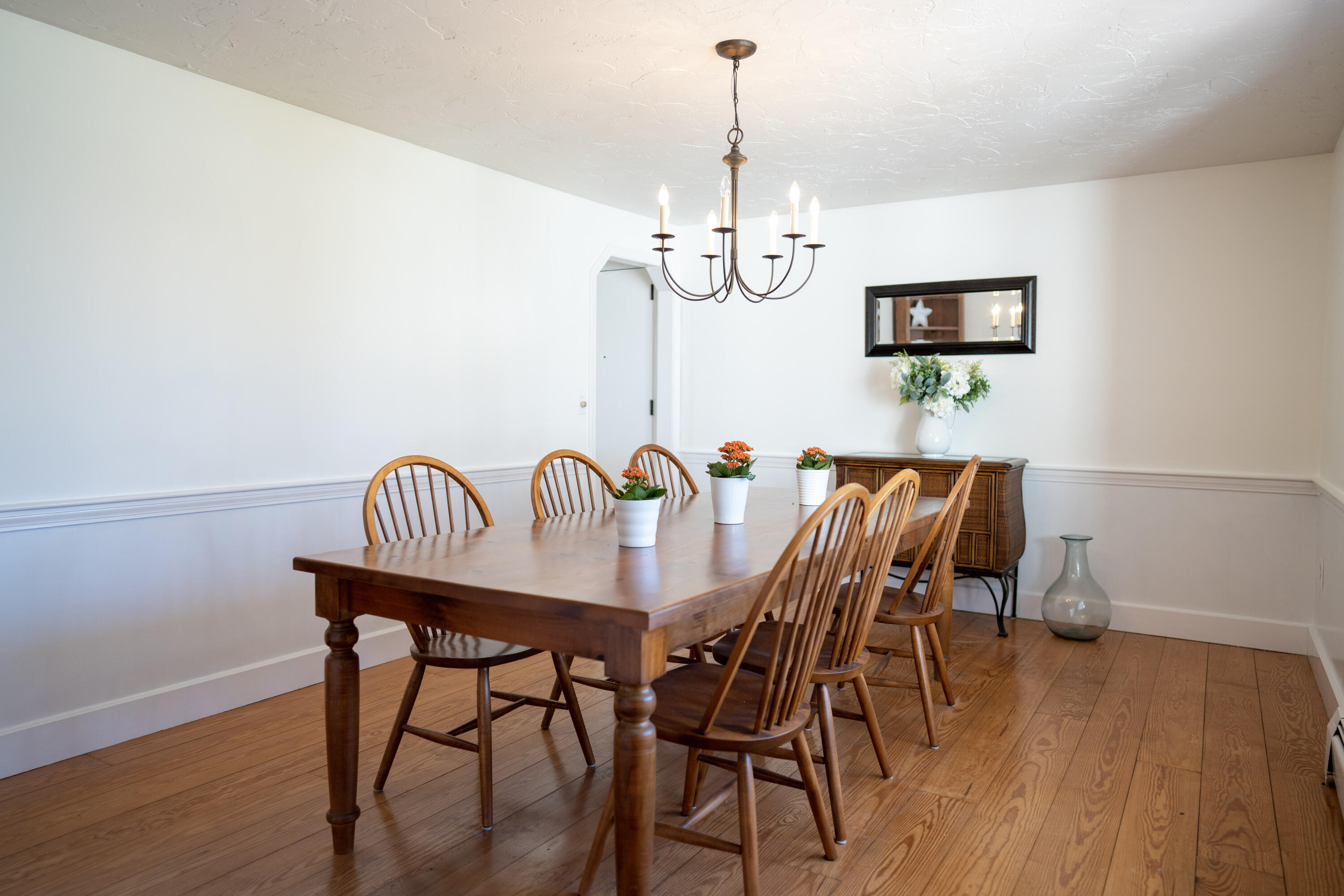 72 Cove Road South Dennis, MA 02660 - Photo 12 of 37 a view of a dining room with furniture wooden floor and chandelier