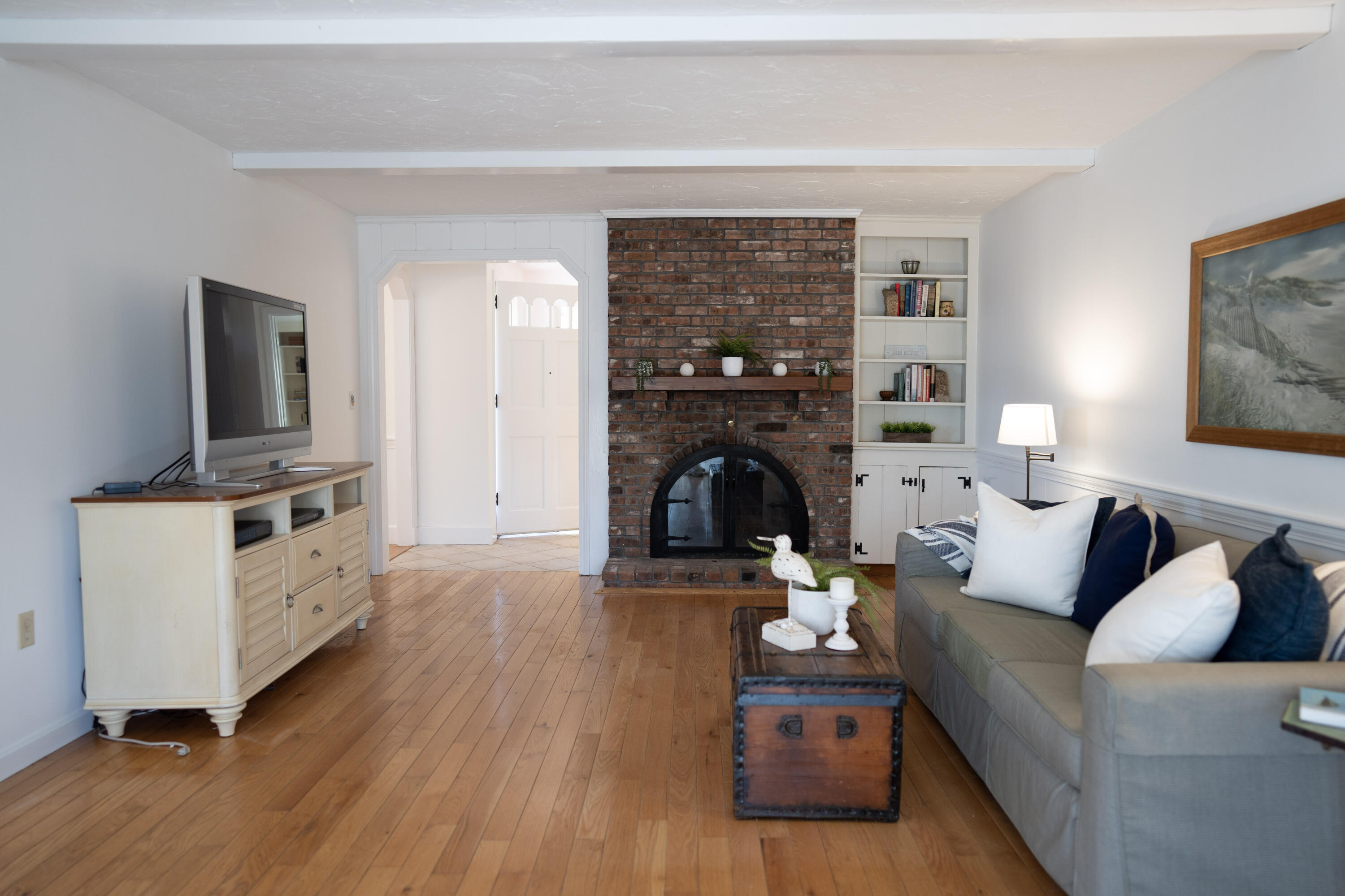 72 Cove Road South Dennis, MA 02660 - Photo 14 of 37 a living room with furniture and a fireplace