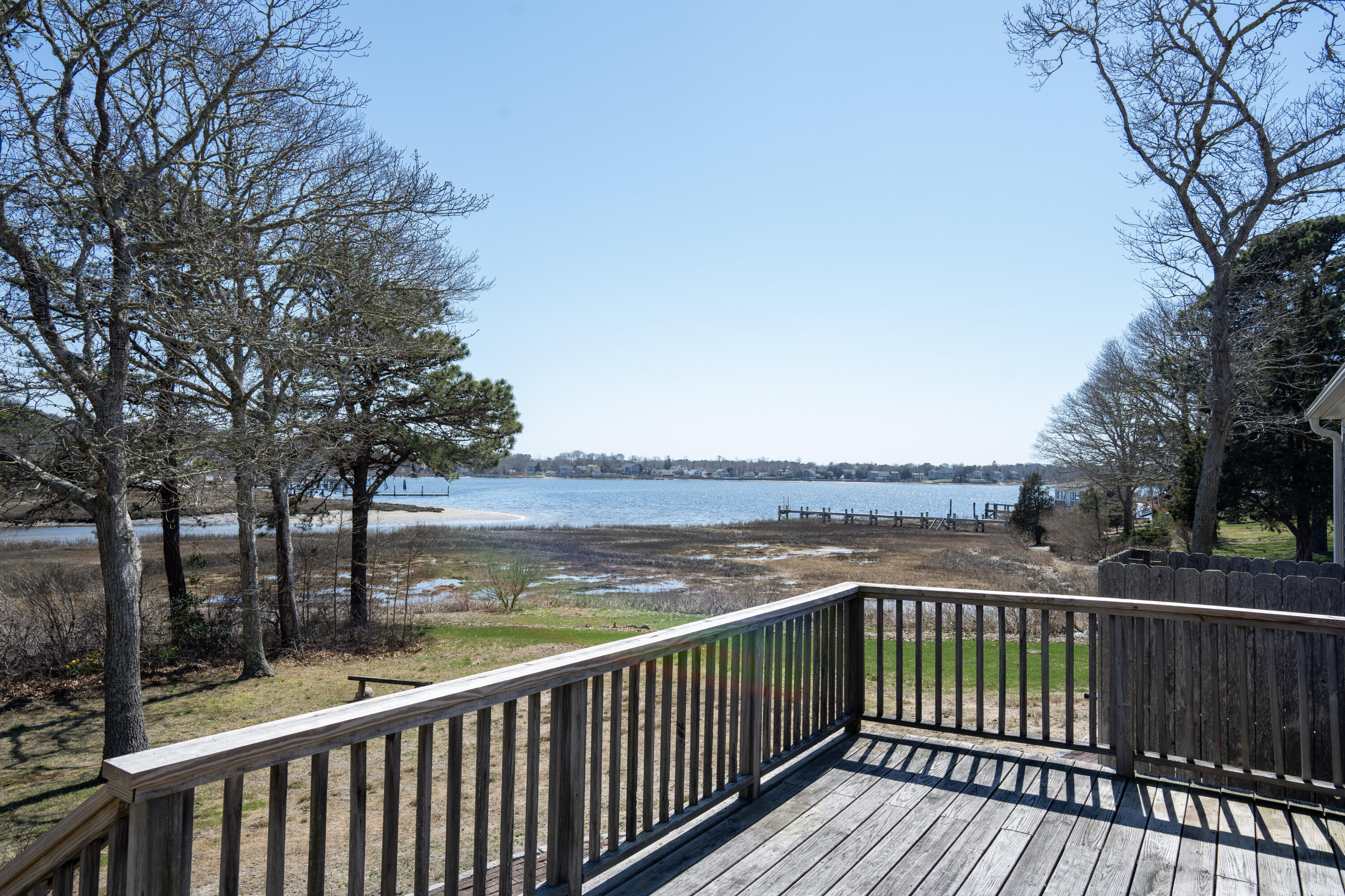 72 Cove Road South Dennis, MA 02660 - Photo 2 of 37 a view of a balcony with wooden floor and fence