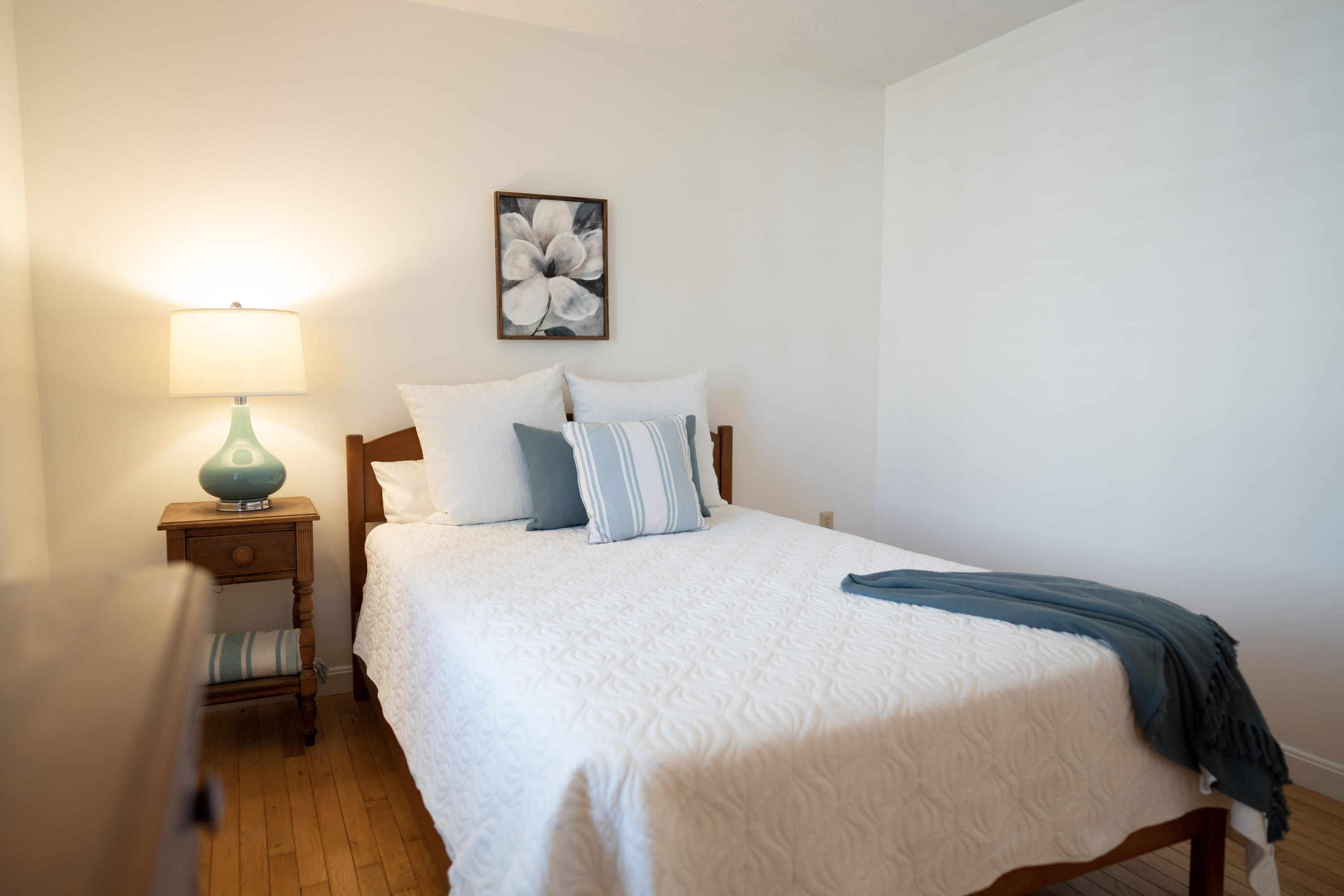 72 Cove Road South Dennis, MA 02660 - Photo 23 of 37 a bedroom with a bed and wooden floor