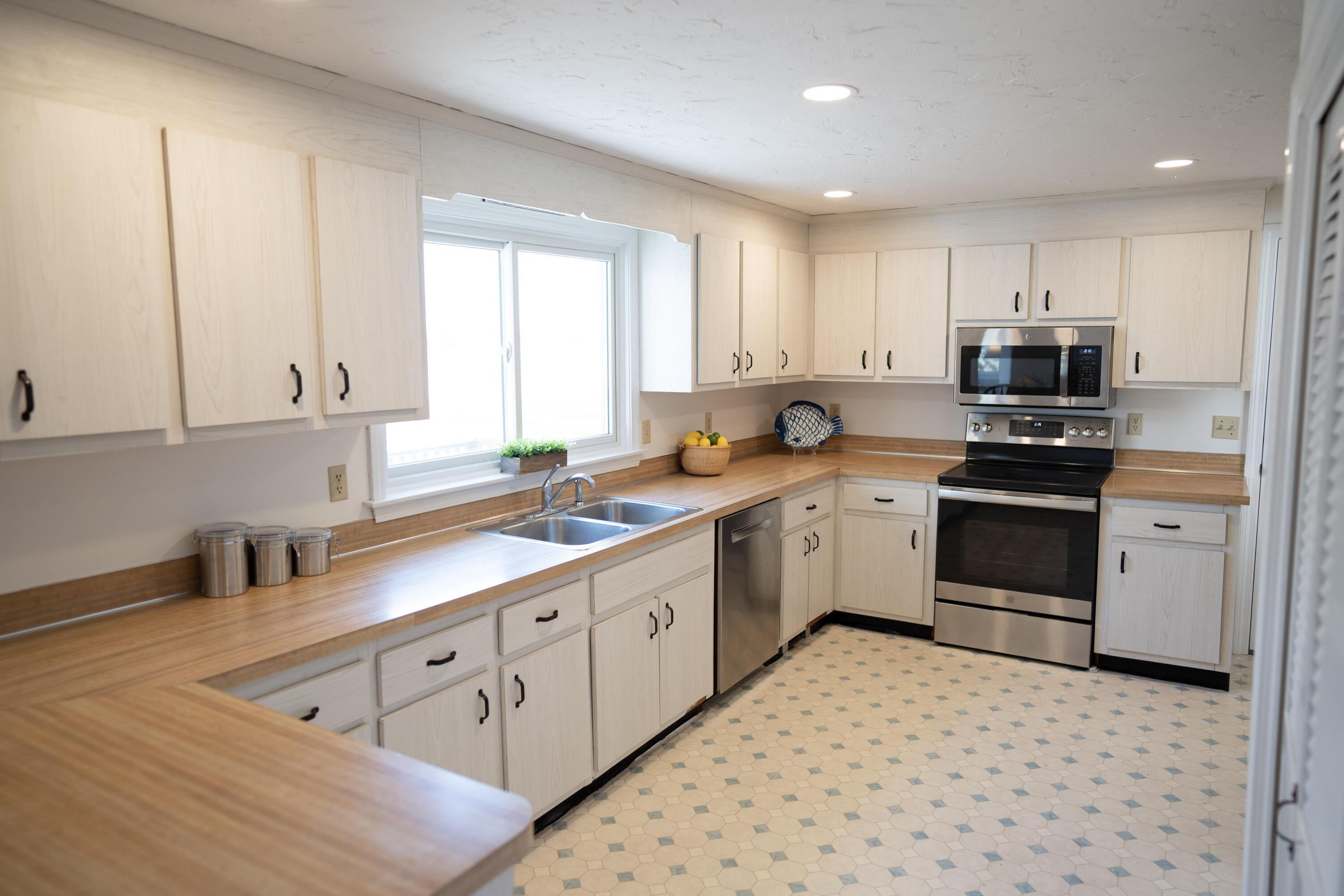 72 Cove Road South Dennis, MA 02660 - Photo 9 of 37 a kitchen with granite countertop white cabinets and white appliances