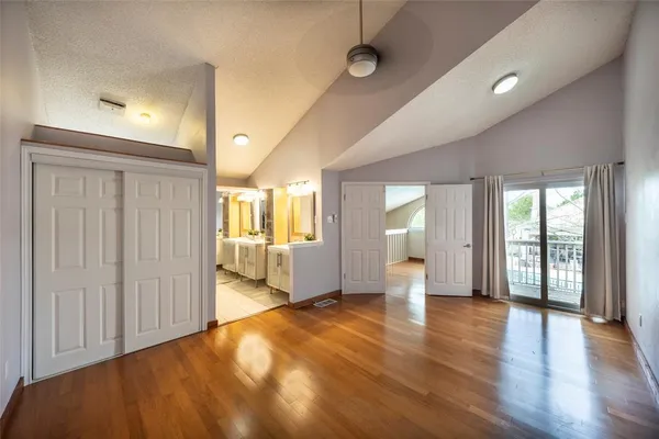 a view of a room with wooden floor and white walls