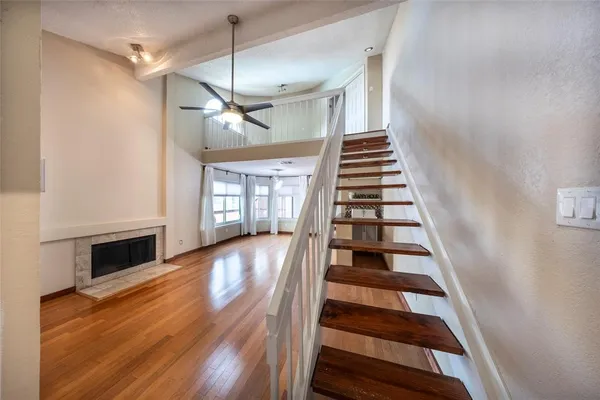 a view of entryway and hall with wooden floor
