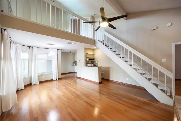 a view of staircase with white walls and a window