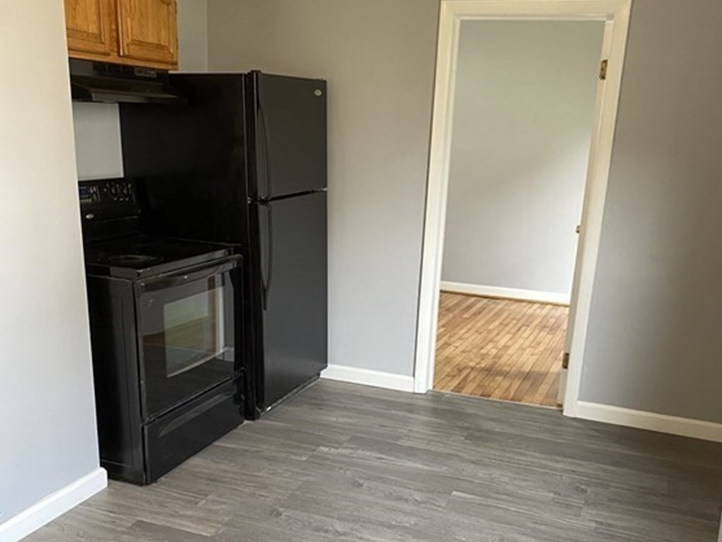 65 Prospect Street Worcester, MA 01605 - Photo 15 of 39 a view of an empty room with wooden floor and a window