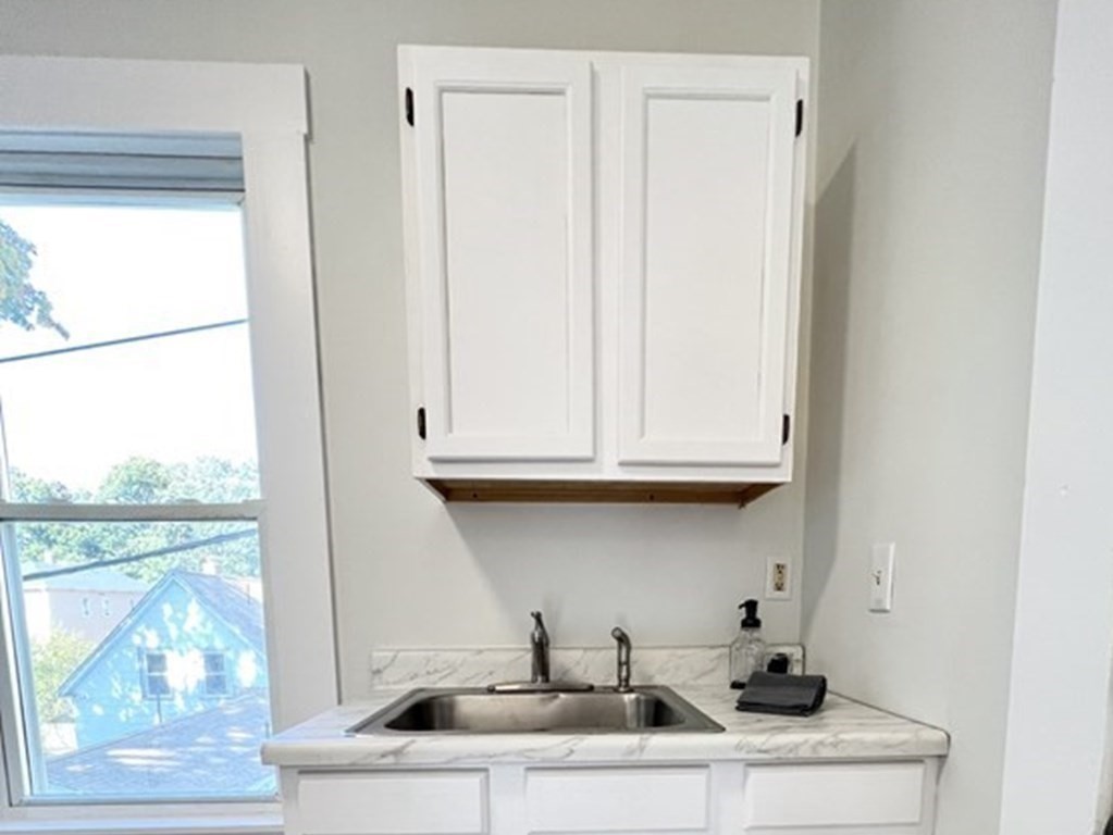 65 Prospect Street Worcester, MA 01605 - Photo 21 of 39 a kitchen with a sink and a window