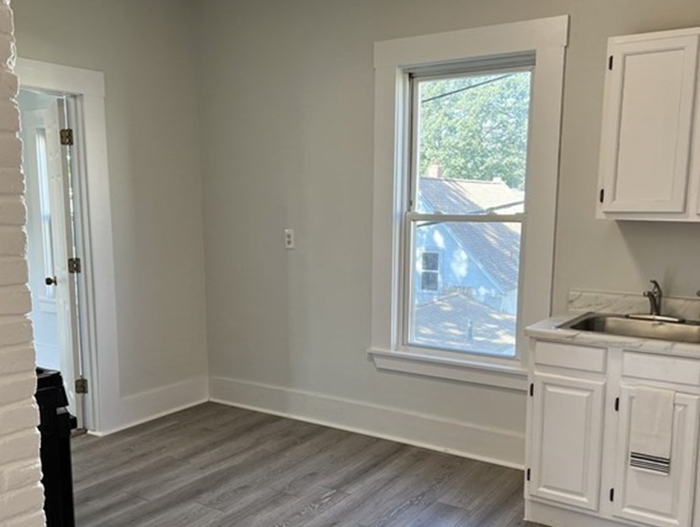 65 Prospect Street Worcester, MA 01605 - Photo 23 of 39 an empty room with wooden floor and windows