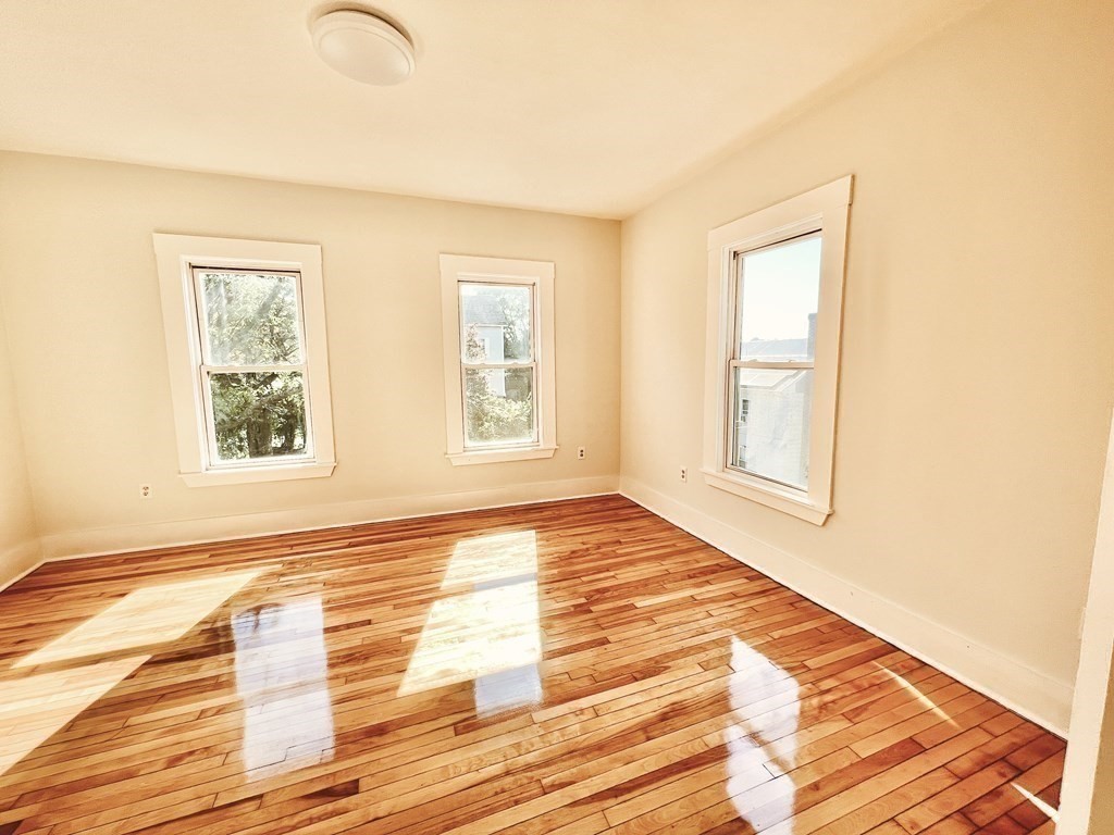 65 Prospect Street Worcester, MA 01605 - Photo 25 of 39 a view of an empty room with wooden floor and a window