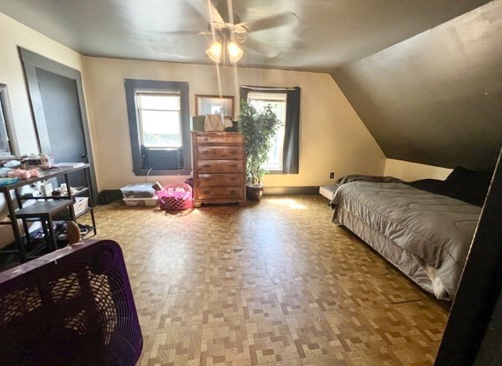 65 Prospect Street Worcester, MA 01605 - Photo 29 of 39 a bedroom with furniture and a large window